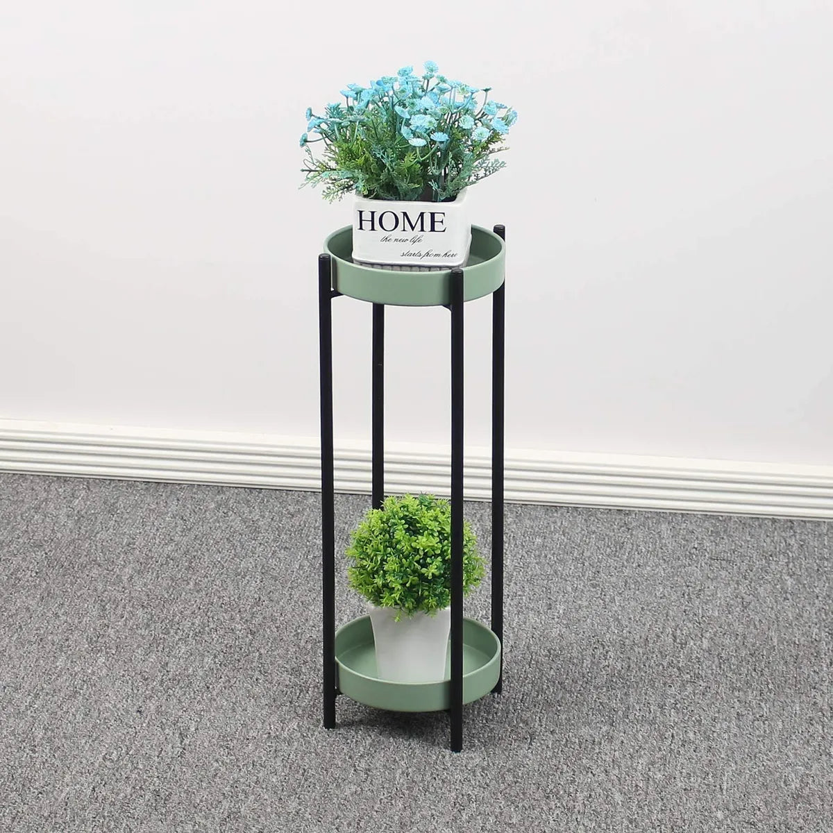 Green metal floor-standing plant stand with a black Stand