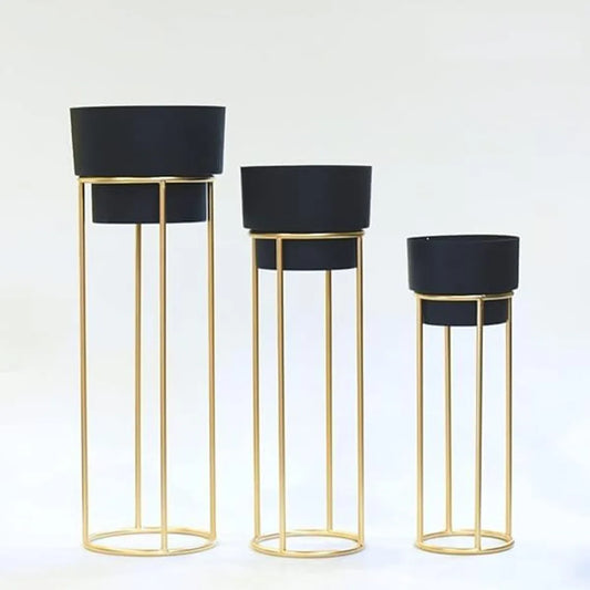 Golden metal floor-standing plant stand with a black pot